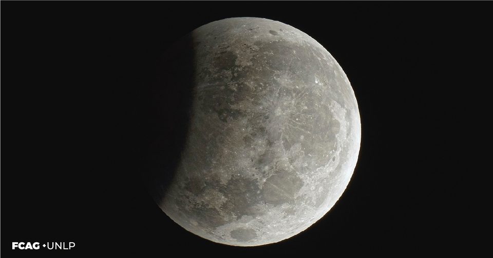 La imagen corresponde a la Luna con una sombra que aparece a la izq. y la eclipsa parcialmente. 